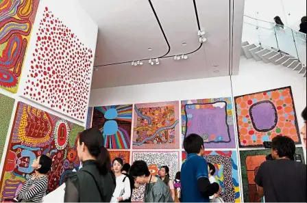  ??  ?? Window to the soul: Journalist­s admiring Kusama’s art during a press preview of her museum in Tokyo. — AFP