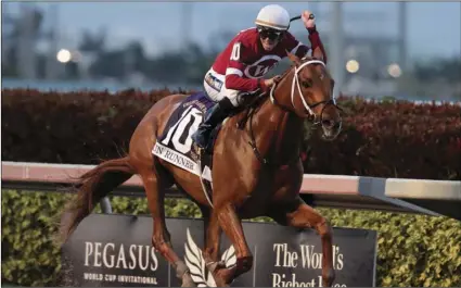  ??  ?? In this Jan. 27, 2018, file photo, jockey Florent Geroux rides Gun Runner (10) past the finish line to win the Pegasus World Cup Invitation­al horse race, at Gulfstream Park in Hallandale Beach, Fla. AP PHOTO/LYNNE SLADKY