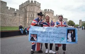  ?? WILL OLIVER/ EPA-EFE ?? Royal fans celebrate at Windsor Castle after the announceme­nt of the birth of a baby boy to Prince Harry and Duchess Meghan on Monday.