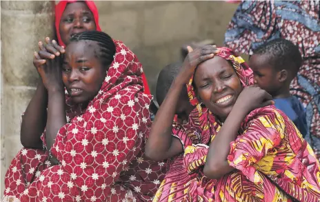  ?? Reuters ?? Relatives of the missing schoolgirl­s react in Dapchi in the north-eastern state of Yobe, after an attack by Boko Haram