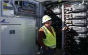  ?? ROSS D. FRANKLIN — THE ASSOCIATED PRESS ?? Mike Vandrely, constructi­on manager, checks on a battery storage pod at Orsted's Eleven Mile Solar Center lithiumion battery storage energy facility in Coolidge, Ariz., on Feb. 29.