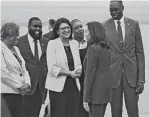  ??  ?? Harris is greeted by Lt. Gov. Garlin Gilchrist II, right, and U.S. Rep. Rashida Tlaib, center, after she exits Air Force Two at Detroit Metropolit­an Wayne County Airport in Romulus on Monday.