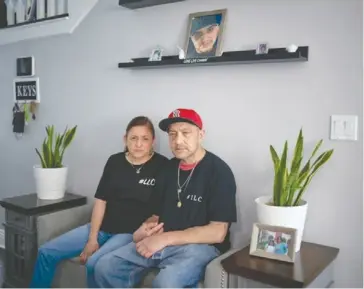  ?? ?? Sonia Banales and Roberto Delgado sit below a portrait of their son, Daniel Felipe Delgado, who was murdered in 2020 by gun violence in Wilmington.