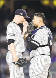  ?? Emilee Chinn / Getty Images ?? The Yankees’ J.A. Happ talks with Gary Sanchez in Game 1 of the ALDS on Friday.