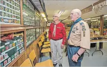  ?? BOB TYMCZYSZYN THE ST. CATHARINES STANDARD ?? Tony Roberts and Bob Prentice look over some of the memorabili­a on display at the Scouting Museum in Niagara Falls. The museum is in the process of relocating to the Niagara Military Museum.