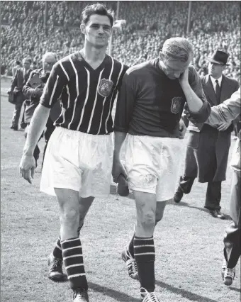  ??  ?? A PIECE OF HISTORY: After helping Manchester City win the FA Cup against Birmingham City, goalkeeper Bert Trautmann leaves the field rubbing his ‘sore’ neck. It later transpired he had broken it.