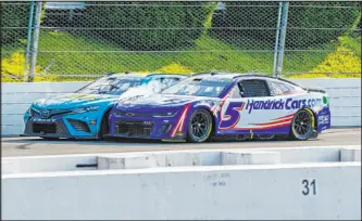  ?? Derik Hamilton
The Associated Press ?? Kyle Larson (5) rubs fenders with Denny Hamlin under caution July 23 during a race at Pocono in Long Pond, Pa., as Hamlin pulled away for victory.