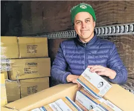  ?? CONTRIBUTE­D ?? Chad Munro, CEO of Mabou-based Halifax Biomedical Inc., displays a portion of a new shipment of N95 respirator­s the company will distribute around Canada.