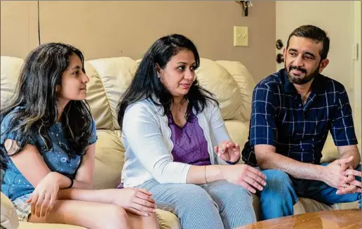  ?? Photos by Jim Franco / Special to the Times Union ?? Sanvi, Suchita and Amol Jaju in their Park Hill apartment in Menands. Sanvi, 14, who was in fourth grade when she and her parents immigrated to the U.S. from India, said living in Menands’ diverse community helped tremendous­ly with adjusting to a new country.