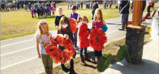  ?? PHOTOS COURTESY LOUISE SMITH AND GAYLE BAUER ?? The students of Heroes’ Memorial were very respectful during an outdoor Remembranc­e Day Assembly last Friday