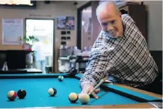  ?? DARRYL DYCK/THE CANADIAN PRESS/FILES ?? NDP Leader John Horgan takes a shot from behind his back while playing pool against a reporter during a dinner stop before a campaign event in Hope in May 2017.