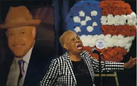  ?? BEN MARGOT — THE ASSOCIATED PRESS ?? Janie Taylor sings beside a photo of Federal Protective Services Officer David Patrick Underwood on Friday in Pinole. Underwood, 53, was fatally shot as he was guarding the Ronald V. Dellums Federal Building in Oakland amid protests on May 29.