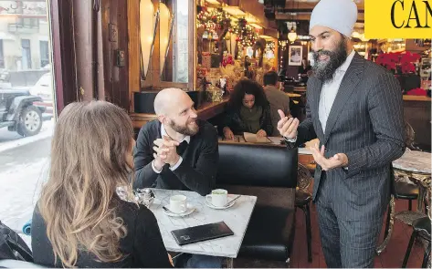  ?? GRAHAM HUGHES / THE CANADIAN PRESS ?? NDP Leader Jagmeet Singh speaks to a man and a woman in a coffee shop during a tour of the Montreal borough of Outremont in December. Prime Minister Justin Trudeau has finally called a byelection for Burnaby South, where Singh hopes to win a federal seat.