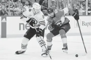  ?? SAM NAVARRO USA TODAY Sports ?? Boston Bruins defenseman Mason Lohrei, left, moves the puck past Florida Panthers center Kevin Stenlund during the second period on Monday in Sunrise, Florida.