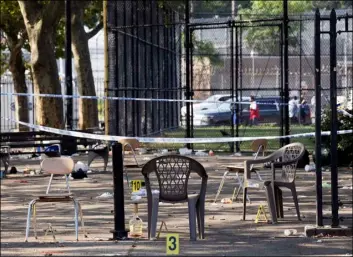  ?? AP PhoTo/MArk LennIhAn ?? Yellow evidence markers are placed next to chairs at a playground in the Brownsvill­e neighborho­od in the Brooklyn borough of New York, on Sunday.