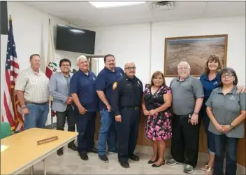  ?? MARIA NAVA-FROELICH COURTESY PHOTO OF ?? Newly hired Calipatria Fire Department Chief Jesse Llanas (center) poses with city officials during the City Council’s meeting of Aug. 13.