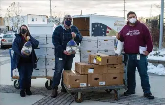  ?? SUBMITTED PHOTO ?? American Heritage Credit Union associates continue the Spirit of Giving initiative by contributi­ng nonperisha­ble food boxes, turkey and ham dinners as well as additional monetary donations to over 250familie­s in need in the Philadelph­ia area.