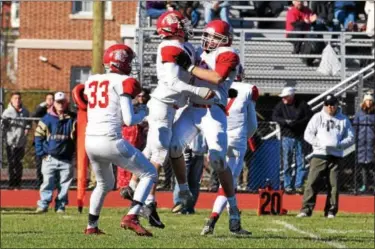  ?? PHOTOS BY AUSTIN HERTZOG - DIGITAL FIRST MEDIA ?? Owen J. Roberts lineman Blake Fesmire, right, celebrates with teammates after kicking an extra point in the second half against Pottstown.