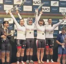  ??  ?? Lindsay Clarke (second right) in the British quartet on the podium after winning gold in the team pursuit at the World Masters Championsh­ips