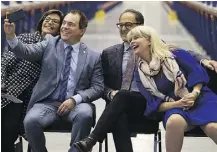  ?? GREG SOUTHAM ?? Ivonne Martinez, president of the Alberta Liquor Store Associatio­n, left, leans over as Alain Maisonneuv­e, president and CEO of the Alberta Gaming, Liquor and Cannabis Commission, takes a selfie with Finance Minister Joe Ceci and St. Albert Mayor Cathy Heron at the opening of a new liquor distributi­on centre on Wednesday in St Albert.