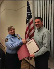  ?? SUBMITTED ?? Jennifer Calhoun Hurban, left, an administra­tive assistant with Fairport Harbor Village Police Department, is congratula­ted on Feb. 21by Mayor Timothy Manross after being named as the community government’s 2022 Employee of the Year. Hurban also serves as clerk of the Fairport Harbor Traffic Violations Bureau Court, and is the police department’s assistant evidence technician.