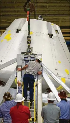  ?? Mark Mulligan / Staff photograph­er ?? Jim Rice, test director for the Orion module mass properties measuremen­t test, puts a pin into place at Johnson Space Center.