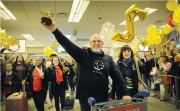  ?? PICTURES: ARMAND HOUGH/AFRICAN NEWS AGENCY (ANA) ?? TRIUMPHANT: Tygerberg Children’s Choir conductor Hendrik D Loock leads his team through the arrival gates at Cape Town Internatio­nal Airport. They won two gold medals in two categories at the 6th World Choir Games.