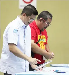  ??  ?? Azmin casts his ballot at a polling centre. — Bernama photo