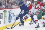  ?? ADAM HUNGER THE ASSOCIATED PRESS ?? Leafs centre John Tavares battles for the puck with Devils centre Kevin Rooney on Thursday night. Tavares scored twice and added an assist.