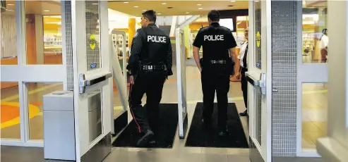  ?? COLE BURSTON/ FOR THE NATIONAL POST ?? Police arrive to monitor a memorial for Barbara Kulaszka, a prominent lawyer for hate propagandi­sts, at a Toronto library last July. The event led to a new policy allowing the refusal of bookings for events likely to promote hate.