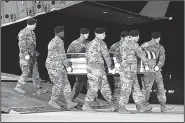  ?? The New York Times/U.S. Air Force/STAFF SGT. AARON J. JENNE ?? The coffin bearing the remains of Staff Sgt. Dustin Wright arrives Oct. 5 at Dover Air Force Base in Delaware. Four months later, tough questions remain about how Wright and three fellow Special Forces troops were caught in a deadly ambush in Niger.