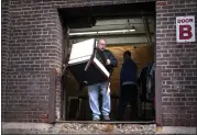  ?? ANGELINA KATSANIS — MINNEAPOLI­S STAR TRIBUNE ?? Bill Breazile, an employee at Furniture Office and Home, brings out a chair for loading on Feb. 1 in Minneapoli­s.