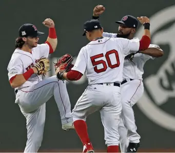  ?? Matt stone / herald staFF File ?? DOING THE DANCE: Boston Red Sox left fielder Andrew Benintendi, left, right fielder Mookie Betts and center fielder Jackie Bradley Jr. celebrate in style in 2017.