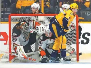 ?? BRUCE BENNETT / AFP ?? Anaheim Ducks goalie John Gibson and teammate Corey Perry get tangled in the net as Filip Forsberg of the Nashville Predators looks on during Game 4 of the Stanley Cup Western Conference finals at Bridgeston­e Arena, Nashville, on Thursday. The Ducks...
