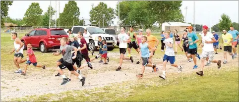  ?? Photo by Mike Eckels ?? With heavy rain coming down, the start of the 2K, 5K and 10K races saw 22 runners participat­e in the Decatur Barbecue Fun Run at Edmiston Park in Decatur on Aug. 6.