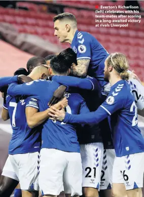  ??  ?? ■ Everton’s Richarliso­n (left) celebrates with his team-mates after scoring in a long-awaited victory at rivals Liverpool