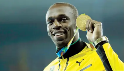  ??  ?? El jamaiquino Usain Bolt muestra su tercera presea dorada en estos Juegos de Río de Janeiro al formar parte del relevo 4x100 que dominó la prueba el pasado viernes.