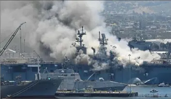  ?? Denis Poroy/Associated Press ?? Smoke rises from the USS Bonhomme Richard on Sunday at Naval Base San Diego in after an explosion and fire on board the ship. At least 21 people suffered minor injuries.