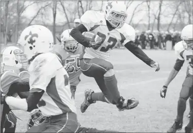  ?? MATTHEW GOURLIE/MOOSE Jaw Times-herald ?? Bishop J. Mahoney Saints tailback Colin Stumborg hurdles a would-be Peacock Tornadoes tackler in the SHSAA
3A provincial football semifinal Saturday at Gutheridge Field in Moose Jaw.