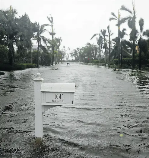  ?? DAVID GOLDMAN / THE ASSOCIATED PRESS ?? A street is flooded as the mammoth 640-kilometre-wide hurricane Irma passes through Naples, Fla., on Sunday.