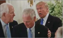  ?? PABLO MARTINEZ MONSIVAIS — ASSOCIATED PRESS ?? Shown at the White House on Wednesday are, from left, Senate Majority Whip John Cornyn, R-Texas, Sen. Ron Johnson, R-Wis., and President Donald Trump.