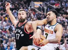  ?? NATHAN DENETTE/THE CANADIAN PRESS ?? Raptor Jonas Valanciuna­s tries to strip the ball from the Denver Nuggets’ Trey Lyles in Toronto, Monday.