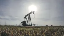  ?? JEFF McINTOSH, THE CANADIAN PRESS ?? A pumpjack works at a well head on an oil and gas installati­on near Cremona, Alta.