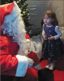  ??  ?? Sofia Haberlin tells Santa what she would like for Christmas.