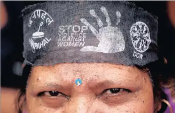  ?? PICTURE: REUTERS ?? OUTRAGE: A woman wears a bandana with a message, during a protest yesterday organised by the Delhi Commission for Women against the rape of an 8-year-old girl in Kathua, near Jammu, and a teenager in Unnao, Uttar Pradesh state, in New Delhi.