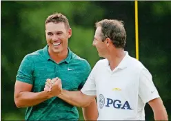  ?? CHARLIE RIEDEL/AP PHOTO ?? Brooks Koepka, left, celebrates with caddie Ricky Elliott after winning the PGA Championsh­ip on Sunday at Bellerive Country Club in St. Louis.