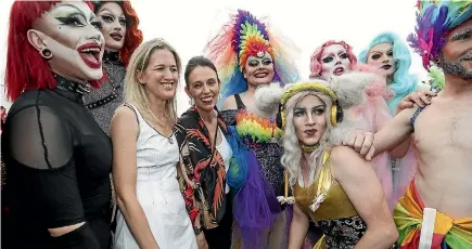  ?? PHOTOS: CHRIS SKELTON/STUFF ?? Cheers and photo requests followed Prime Minister Jacinda Ardern as she marched in Auckland’s Pride Parade on Saturday. Ardern, pictured centre, was flanked by political colleagues and supporters during the annual procession.