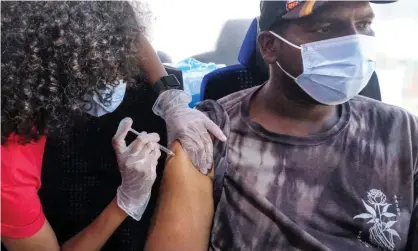  ?? Photograph: Ringo Chiu/ ZUMA Wire/REX/Shuttersto­ck ?? ▲ A man receives a Covid-19 vaccinatio­n dose at a Walgreens mobile vaccine clinic bus in downtown Los Angeles.