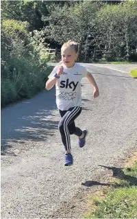  ??  ?? Eight-year-old Manon Phillips from near Peniel, north of Carmarthen, has been running a mile a day for a whole month to raise money for Hywel Dda NHS staff.