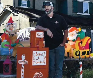  ?? JOEL ROSENBAUM — THE REPORTER ?? Loren Dougherty of Dixon has placed a special mailbox in front of his home in the 2000 block of Rehrmann Drive to collect letters to Santa Claus. Dougherty is making sure that all the letters dropped off find their way to Saint Nick so he can make all the proper deliveries on Christmas Eve.